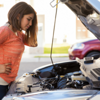 Woman looking under the hood