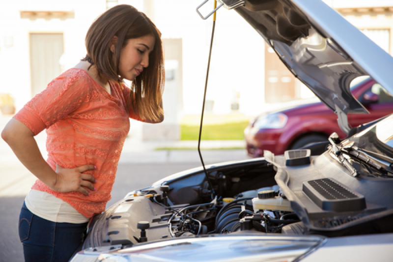 Woman looking under the hood